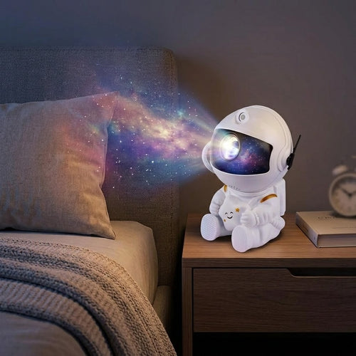 Veilleuse astronaute galaxie assis